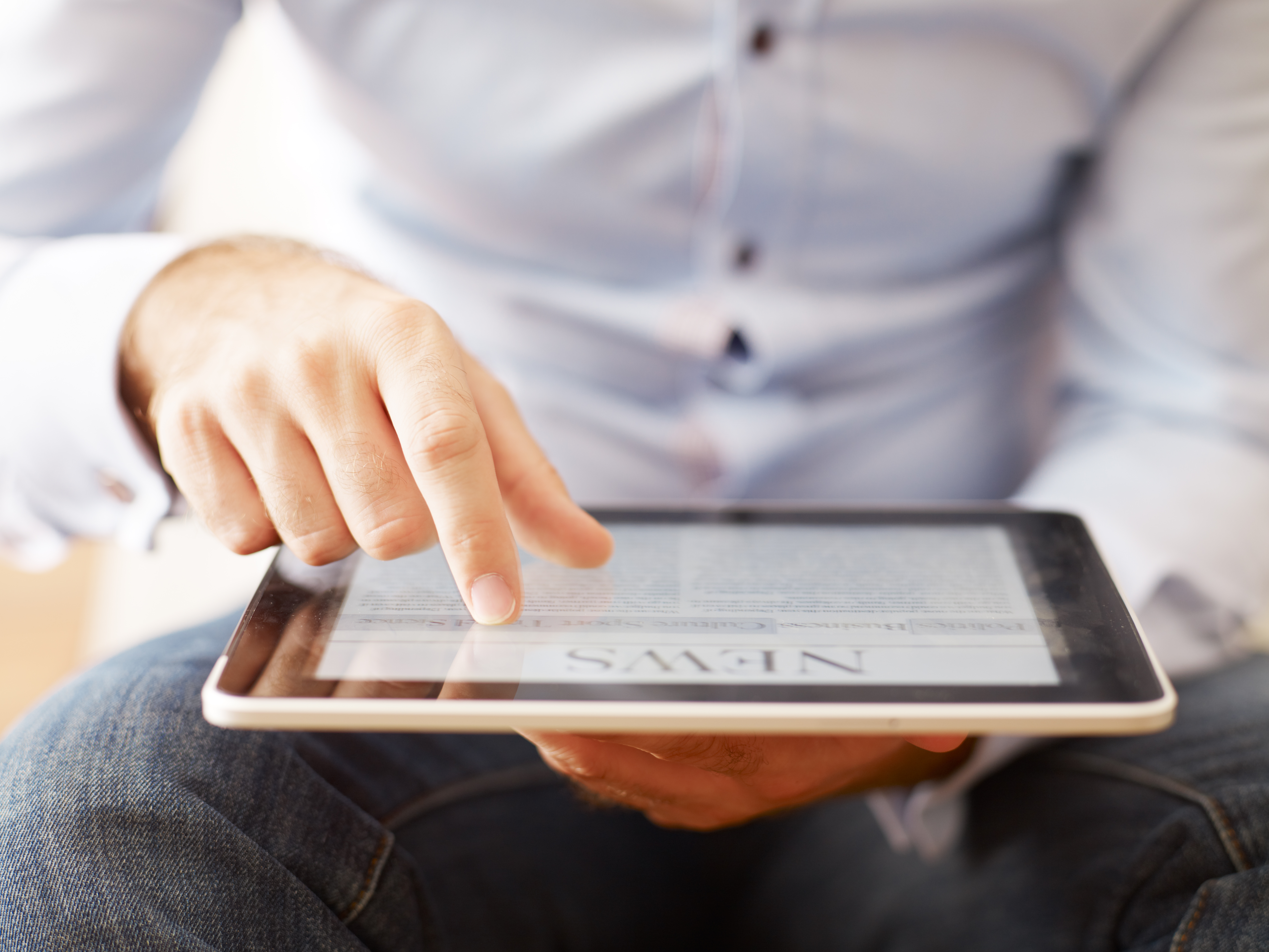man-reading-news-on-the-digital-tablet-171365825_5555x4166